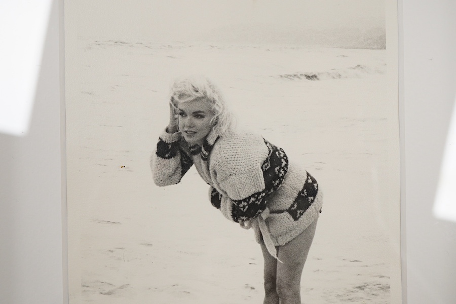 George Barris, a black and white photograph of Marilyn Monroe on a beach, signed in black ink by Barris to the lower edge of the image, stamped to the reverse ‘The Private Collection of Kim Goodwin’, 18 x 12.5cm
